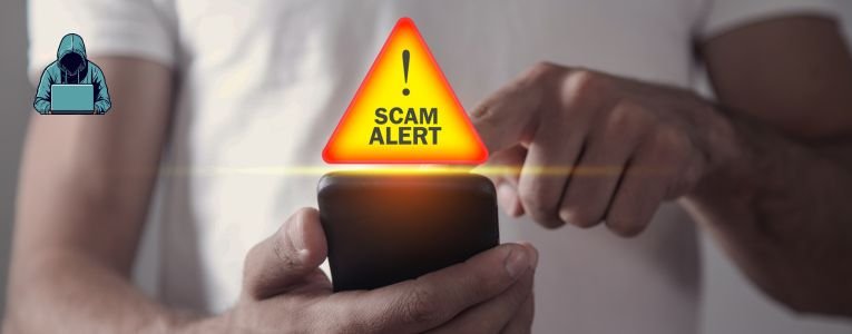 Man holding smartphone. Scam Alert (What is the Intuit e-commerce scam?)