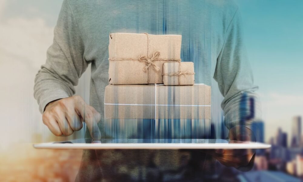 a man using digital tablet with parcel post boxes on screen. Online shopping, e-commerce and delivery concept