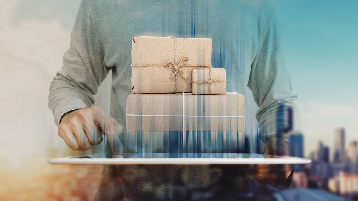 a man using digital tablet with parcel post boxes on screen. Online shopping, e-commerce and delivery concept