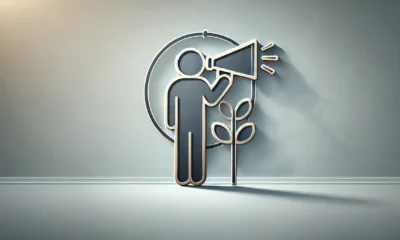 A minimalist, wide-format image featuring a soft gradient background transitioning from light steel blue on the left to soft silver on the right. In the center, an abstract figure with a megaphone represents early-stage startup marketing roles. The icon has a dark slate gray outline with subtle soft gold accents and a light gray shadow for depth. Concept Used For Early Stage Startup Marketing Roles.