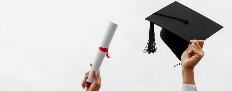 Man hand holding graduation cap, education concept.