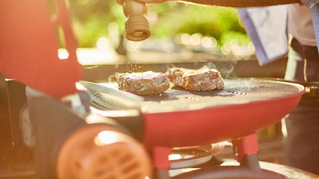 Meat With Seasoning on Red Portable Grill