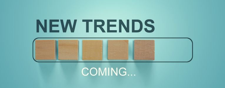 Wooden blocks with the word NEW TRENDS coming in loading bar progress. The concept of new ideological trends of fashion. New objectives. Recent and latest trend. Main trend of changes in the world.