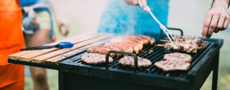 Young people grilling outdoors