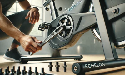 Close-up of an Echelon bike screw being adjusted with a torque wrench to the proper tightness in a home gym setting.