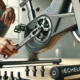 Close-up of an Echelon bike screw being adjusted with a torque wrench to the proper tightness in a home gym setting.