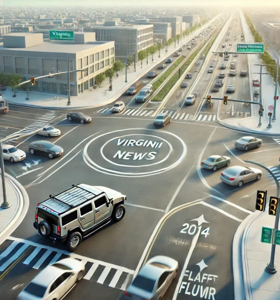 Wide view of Virginia News Continuous Flow Intersection 2014 Hummer, showing a busy urban intersection with continuous flow layout, a 2014 Hummer navigating the design efficiently, and visible traffic signals against a cityscape.